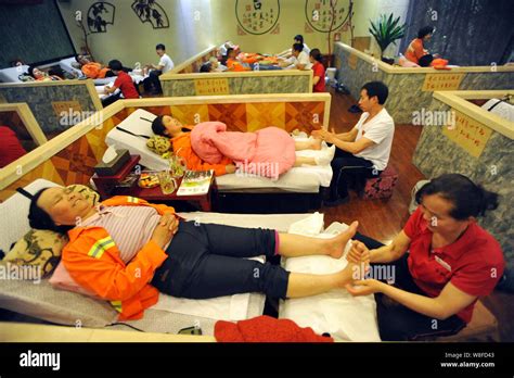 File Chinese Workers Massage Feet Of Street Cleaners At A Foot Massage Parlor In Wuhan City