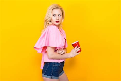Premium Photo Blonde Woman In Pink Blouse With Red Cup