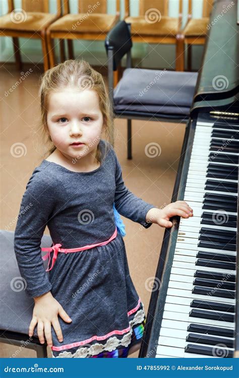 Cute Little Girl Playing Grand Piano Royalty Free Stock Image
