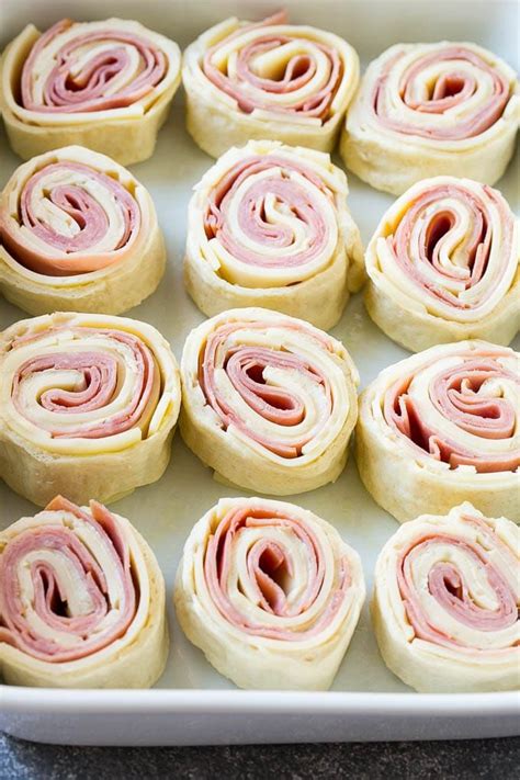 Ham And Cheese Roll Ups On A Baking Sheet Ready To Be Baked In The Oven