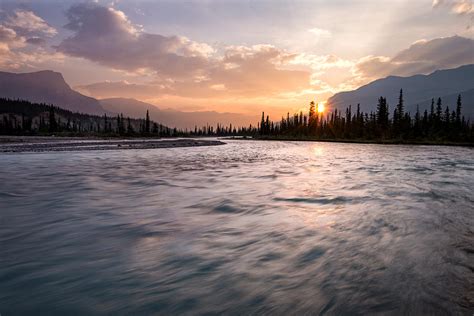 There is something for everyone from sightseeing, fishing, camping, and rafting. Saskatchewan River Dawn Photograph by Matt Hammerstein