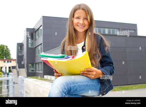 Schoolgirl before school Schülerin vor Schulgebäude Stock Photo Alamy