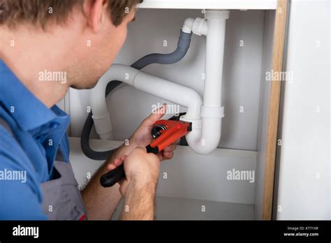 Male Plumber Fixing Sink Pipe Stock Photo Alamy