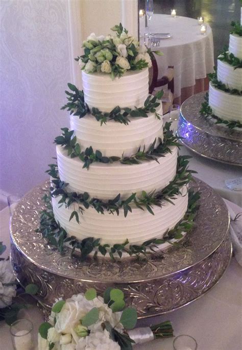 Taste is only one factor to consider when you need cake. Trendy Rustic wedding cake with greens and white rose ...