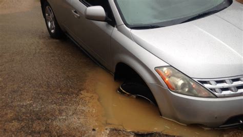 Car Gets Stuck In Pothole