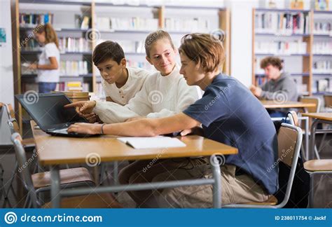Teenage Students Working In Groups In Library Stock Photo Image Of