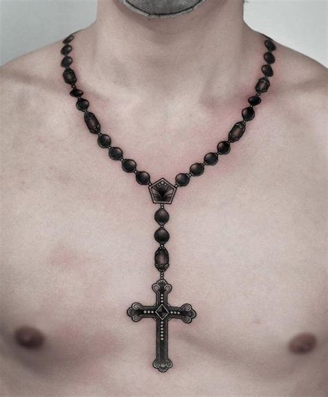 A Shirtless Man Wearing A Rosary Necklace With A Cross On Its Chest