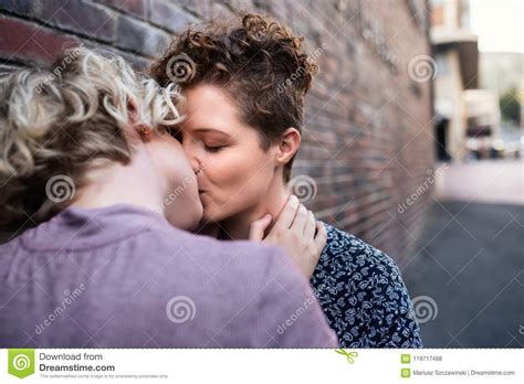 Affectionate Young Leasbian Couple Standing Outside