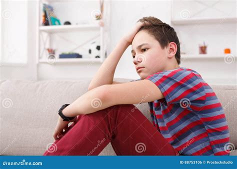 Bored Unhappy Teenage Boy Sitting At Home Stock Photo Image Of