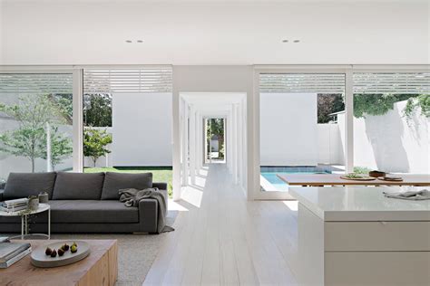 The Minimalist White Exterior Of This Modern House Opens To A Matching