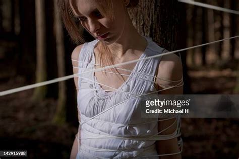 woman tied to tree photos and premium high res pictures getty images