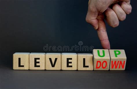 Level Up Or Down Symbol Businessman Turns Cubes And Changes Concept