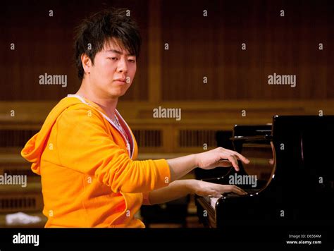 Chinese Star Pianist Lang Lang Sits In Front Of A Grand Piano Playing