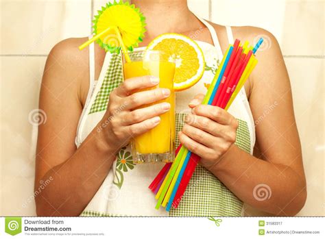 Woman Holding A Glass Of Orange Juice And Drinking Straws Stock Image