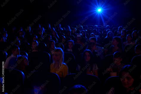 Shot Of A Dark Cinema Auditorium Full Of Kids Watching A Movie Together