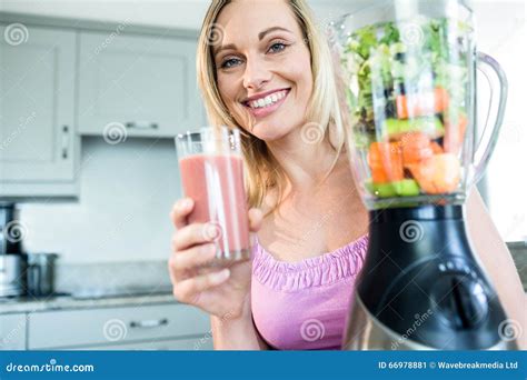 blonde woman drinking a smoothie in the kitchen stock image image of blonde fresh 66978881