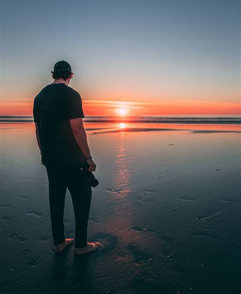 Man Standing On Beach During Sunset · Free Stock Photo