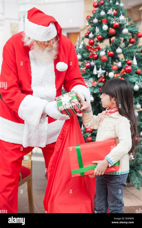 Santa Claus Giving Ts To Girl Stock Photo Alamy