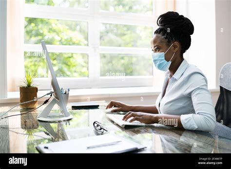 Professional African Woman Business Employee Typing In Office Stock