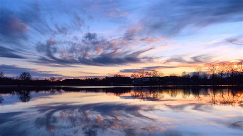 Beautiful Sunset Calm Lake Reflection In The Water Shore Trees Sky