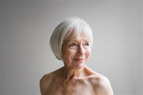 Senior Topless Woman On Simple Grey Background By Stocksy Contributor