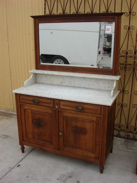 An Old Dresser With A Mirror On It And A Car In The Backgroud