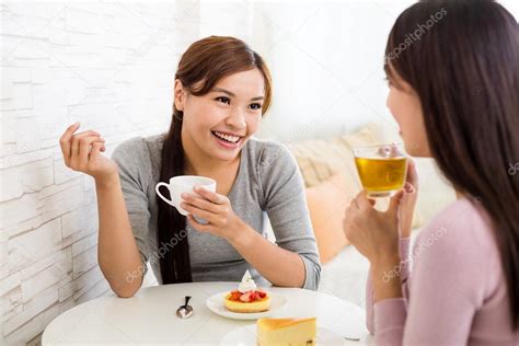 Women Talk To Each Other At Coffee Shop Stock Photo By ©leungchopan