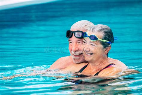 Beautiful Couple Of Two Seniors Together At The Swimming Pool Having