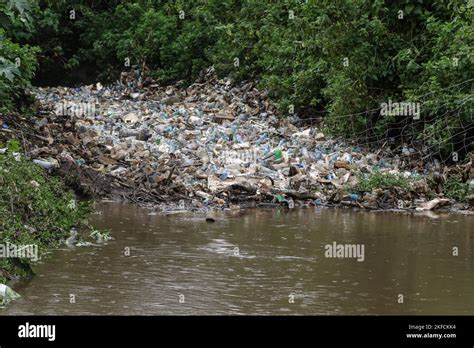 A wire mesh filter placed in a river to stop plastic waste from flowing