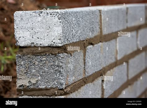 newly laid bricklaying wall with half cement breeze blocks building a