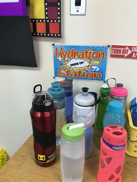 There Are Many Different Water Bottles On The Table And One Has A Sign