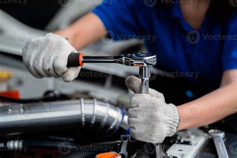 Close Up Of An Expert Mechanic Working On A Vehicle In A Car Service