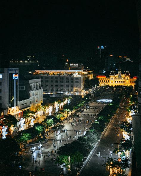 Aerial View Of An Illuminated Cityscape With Buildings And People