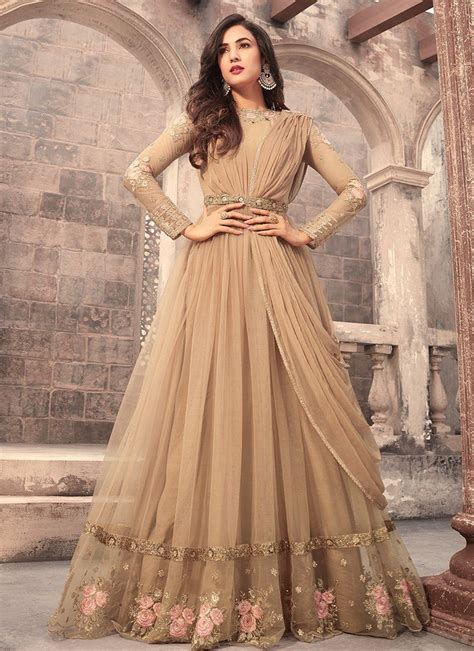 beige embroidered net anarkali suit features a beautiful net top alongside a santoon bottom and