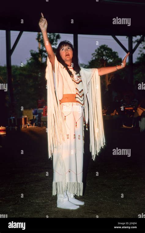 Woman Dressed In Traditional Brain Tanned Fringed Dress Demonstrates Native American Sign