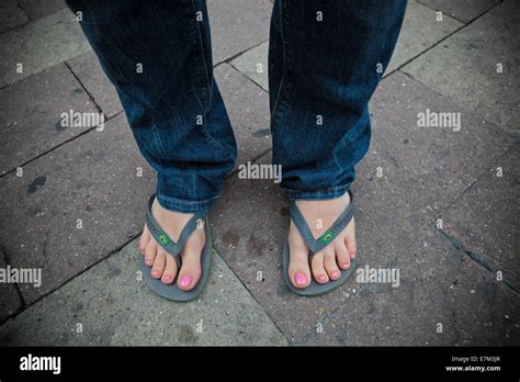 Girl With Nail Polish And Flip Flop Sandals Blue Jeans Relaxing On