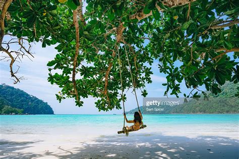 Girl On Swing In Tropical Island Beach Paradise Thailand Photo Getty