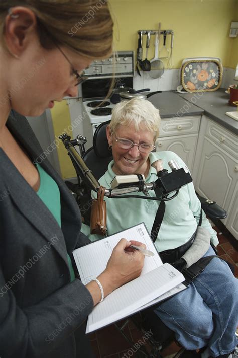 Social Worker Visiting Woman With Cerebral Palsy In Own Home Stock