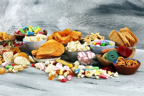 Salty Snacks Pretzels Chips Crackers And Candy Sweets On Table Stock