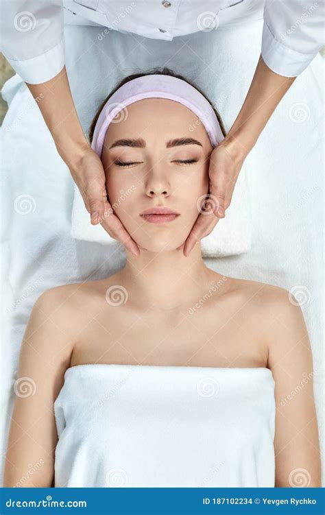 Young Beautiful Woman Receiving The Facial Massage Stock Photo Image