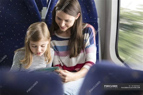 Mother And Daughter Reading Book In A Train — 6 7 Years Millennials