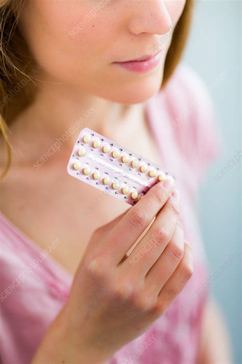 woman holding oral contraception pills stock image c035 0907 science photo library