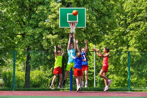 Happy Teenagers Playing Basketball On Playground Stock Image Colourbox