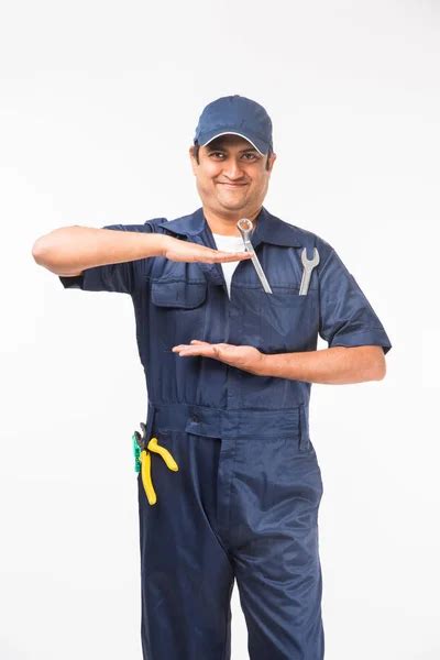 Indian Happy Auto Mechanic Blue Suit Cap Holding Spanner Tool Stock