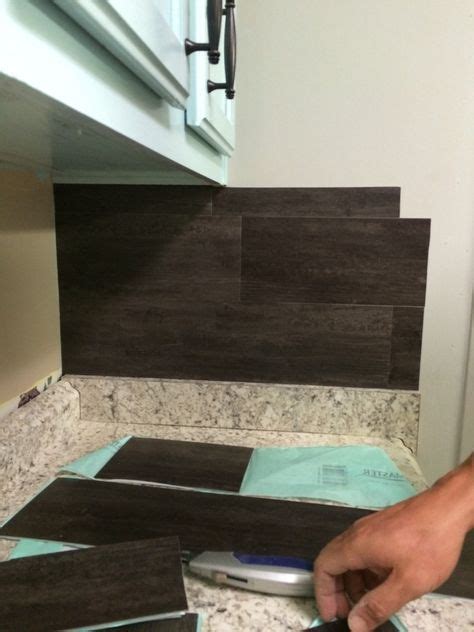 A blogger friend recommended lifeproof luxury plank flooring (previously referred to as. Our $40 Backsplash {Using Vinyl Flooring} - Re-Fabbed | Diy backsplash, Home remodeling, Home diy