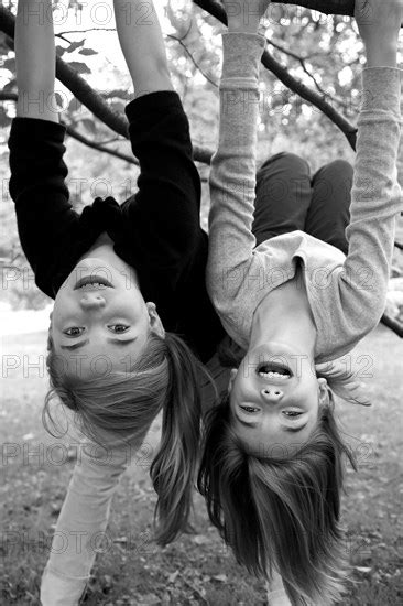 Two Girls Hanging Upside Down Glasshouse Images Photo12