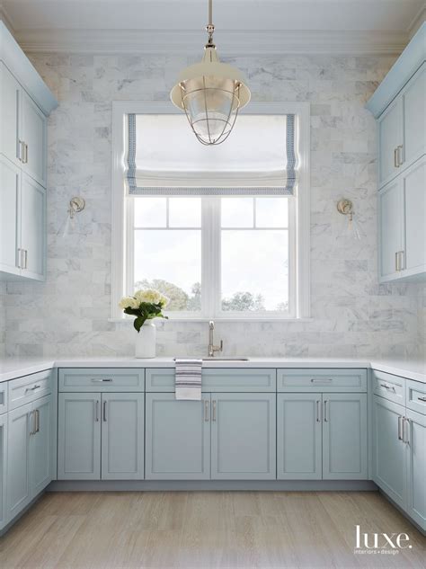 Kitchen cabinets and shelves, kitchen island designs and wall tiles, dining furniture and decorative fabrics blue color allows to create fantastic contrast and add personality to kitchen designs. Soft Blues And Whites Fill A Serene Florida Retreat ...