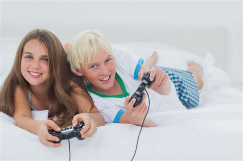 Premium Photo Cheerful Siblings Playing Video Games
