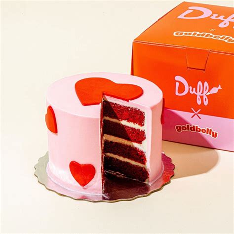 A Red Velvet Cake Sitting Next To A Box