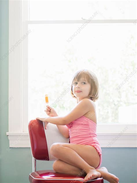Girl Sitting On Red Chair Holding Ice Lolly Portrait Stock Image F Science Photo